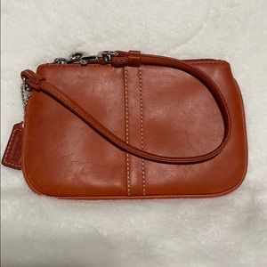Coach, orange leather wristlet